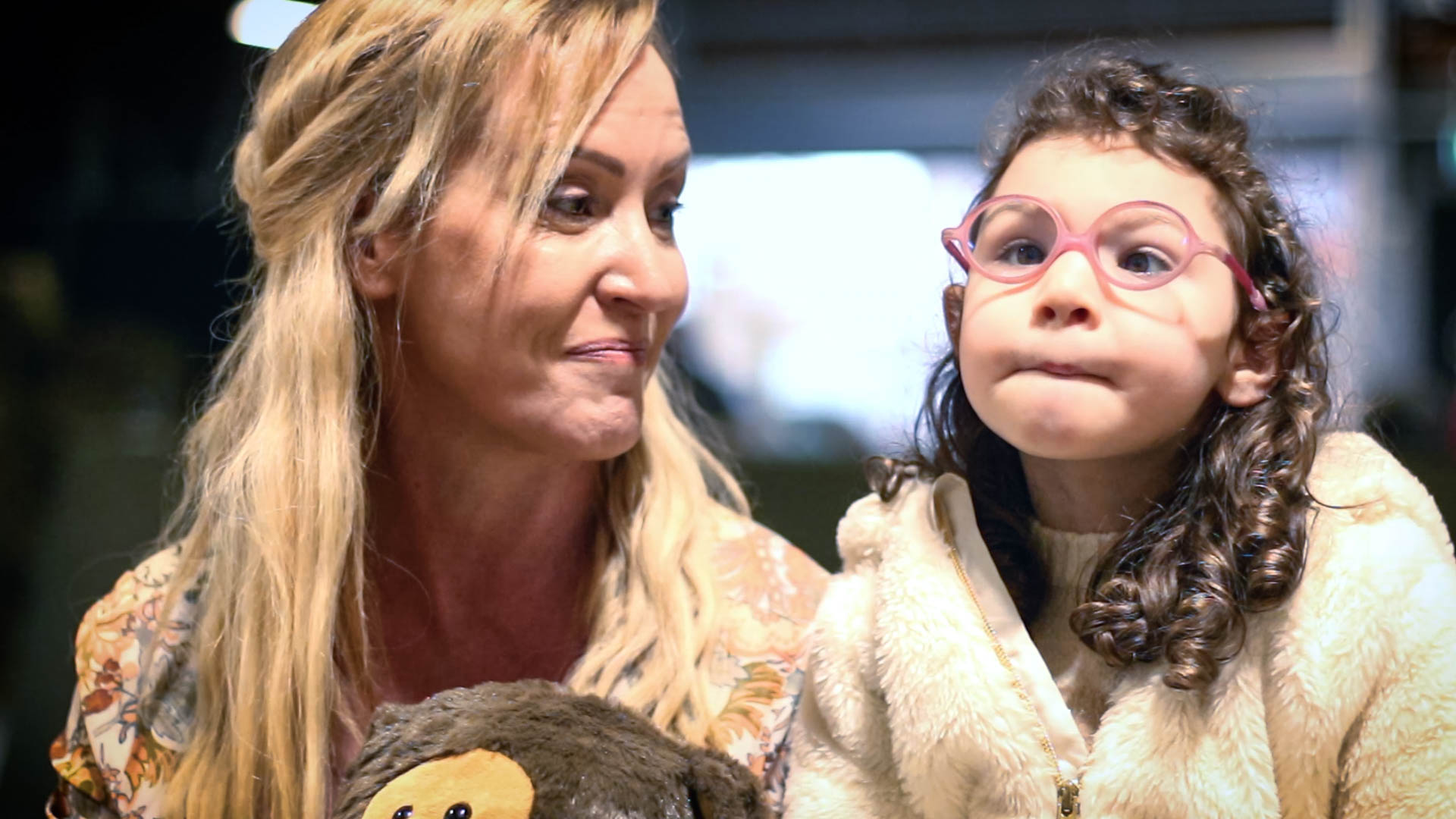 Woman smiles at young girl