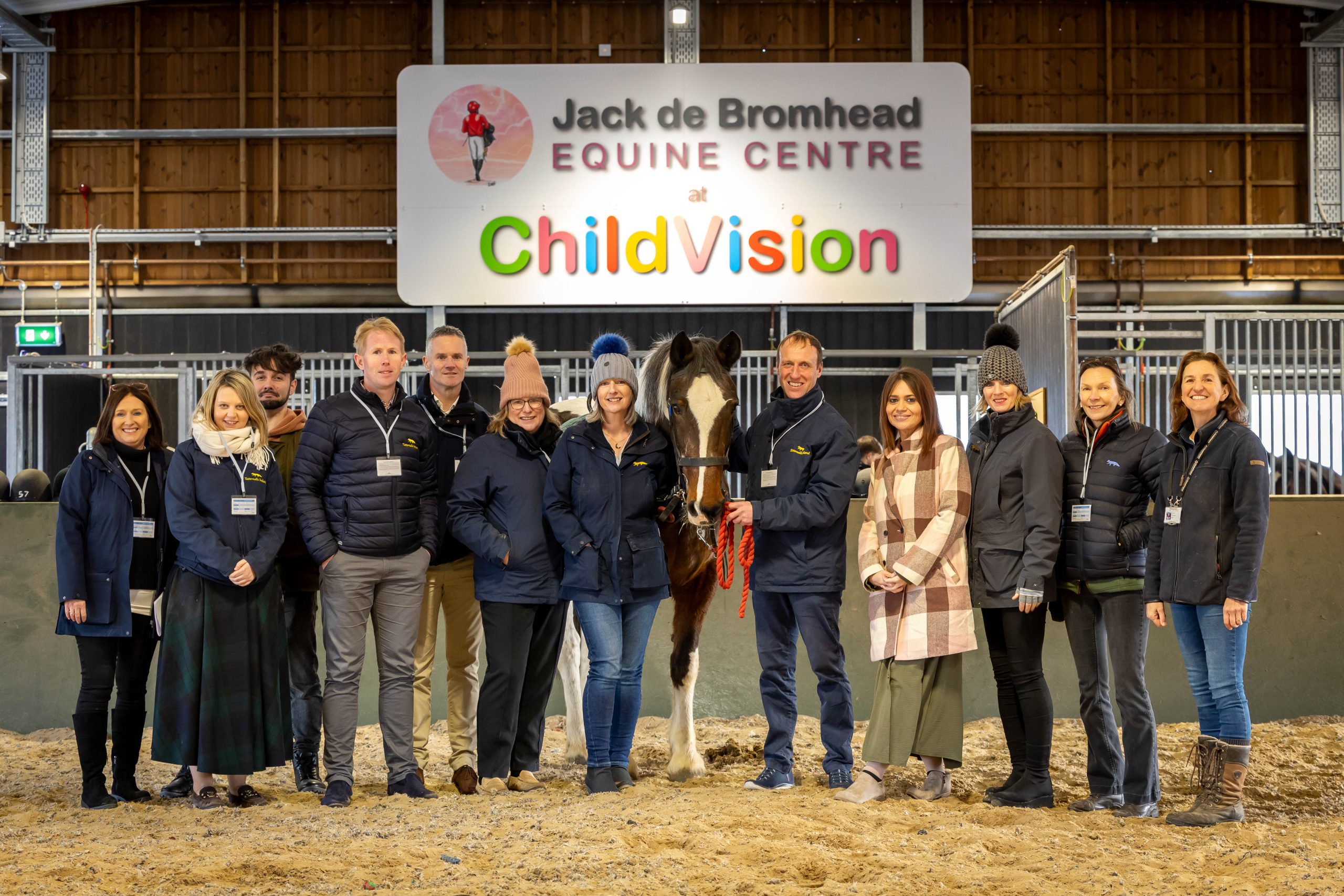 Group Photo of Tattersalls team in the equine arena