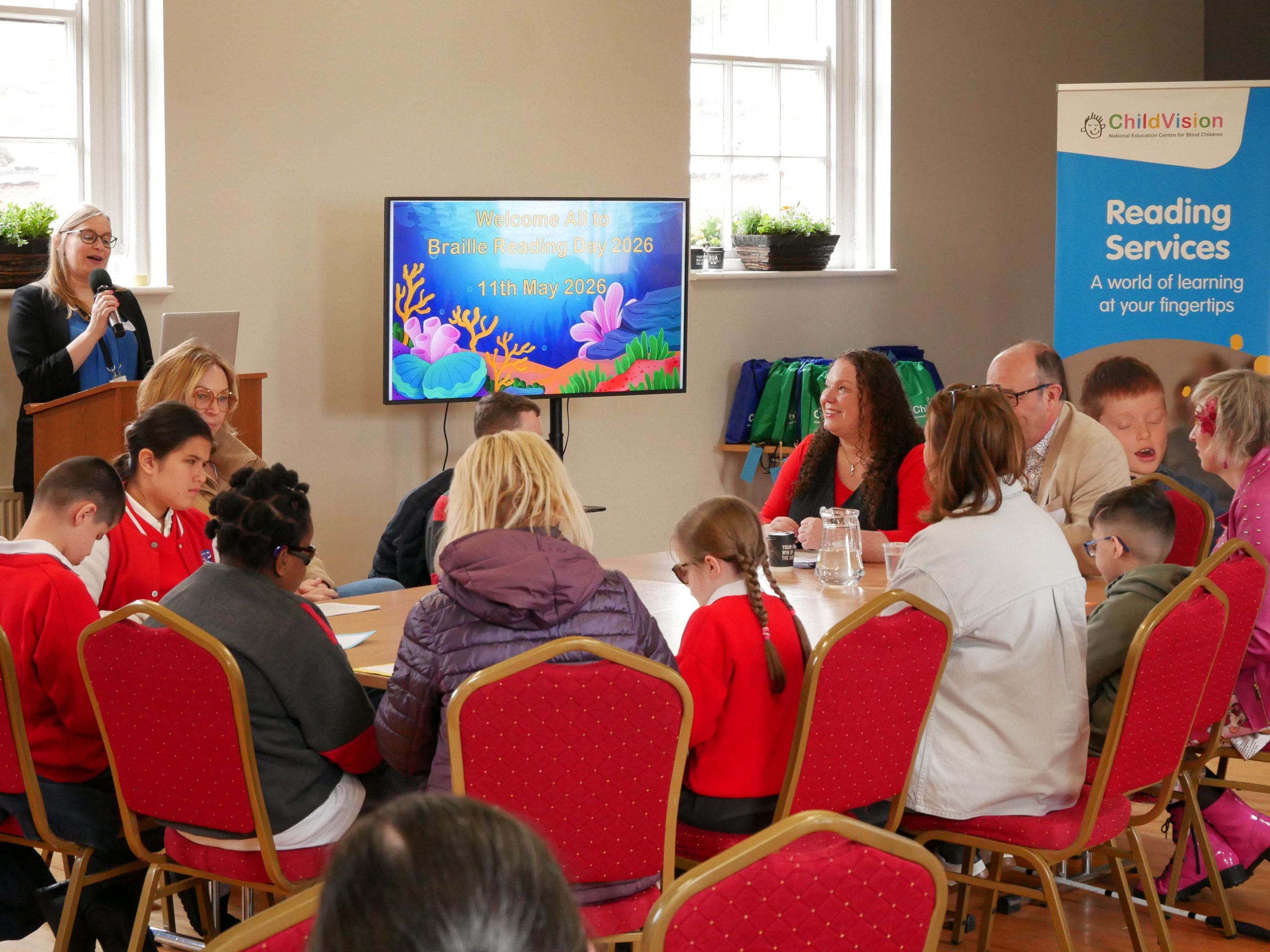 group shot of participants, staff and speakers, sitting around table